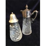 A hallmarked silver claret style jug and a silver topped sugar shaker.