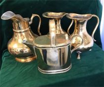 A selection of brass jugs and a watering can