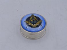 A Silver round pill box with masonic enamel image to the lid