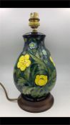 A Moorcroft 21cm tall blue, green and yellow flowers
