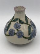 A Cobridge small vase with blue flowers 9cm.