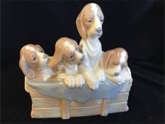 A Lladro 'Dogs In Basket' by Jean Huerta, issued in 1979 and retired in 1986