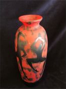 An Okra red glass vase with dancing figure decoration