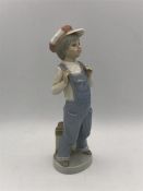 A Lladro boy in overalls with accordion.