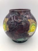 A Moorcroft vase, purple grounds with yellow flowers. 17cm.