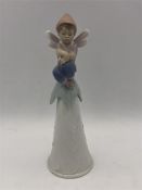 A Lladro bell, fairy on top.