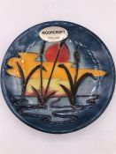 A Moorcroft small plate with a Bull rushes and sunset design.