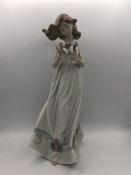 A Lladro figure a woman with a box of butterflies.