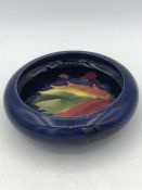 A Moorcroft, circa 1945, dark blue and floral vase 12cm diameter