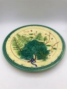 A Majolica plate 25cm in diameter with green fern and white flower decoration