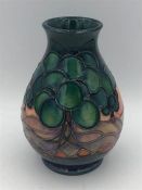 A Moorcroft vase 13cm tall, green tree.theme.