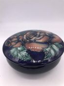 A Moorcroft lidded bowl, powder bowl with rose decoration