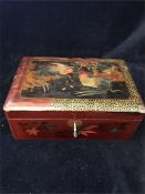 A lacquered jewellery box with cockerel design and key.