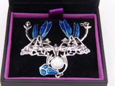 A silver Art Nouveau style pendant necklace set with enamel and opal panel.