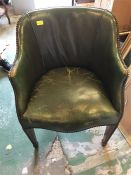 A green leather club chair.