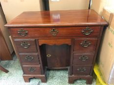 A Ladies kneehole writing desk in mahogany, with glass top