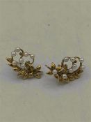 A pair of 9ct gold earrings with seed pearls