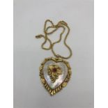 An Asian gold heart shaped pendant on an Asian gold chain
