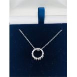 A 14ct white gold circular diamond set pendant necklace