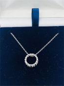 A 14ct white gold circular diamond set pendant necklace