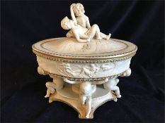A Porcelain lidded centrepiece with cherub detail to top and legs.
