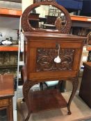 A Mirror backed Butlers table with carved drop front and key.