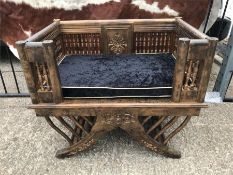 A Pair of throne style chairs with pillar backs and carved flowers and inset cushions.