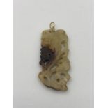 A Chinese white jade pendant on gold setting.