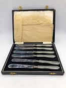 A Boxed set of six butter knives with grey handles.