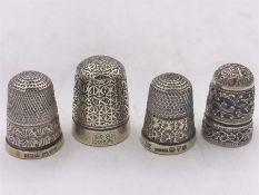 Four silver thimbles