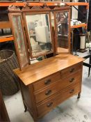 A Dressing table and mirror on castors, two over two with brass handles.