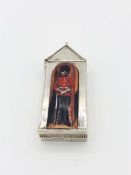 An unusual Sterling silver vesta in the form of a Sentry box with enamel image of a guard.