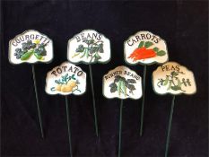 A set of six cast iron vegetable signs for the garden