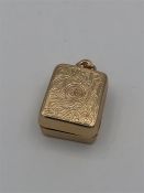 A rose Asian gold holder for a miniature copy of the Koran.
