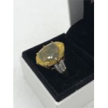 A Citrine ring with diamond shoulders on a 9ct yellow gold mount