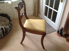 A Set of four cane seated chairs with additional seat pads