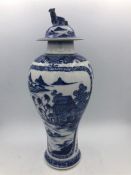 A Blue and White Oriental lidded vase with Foo Dog finial. 29cm.