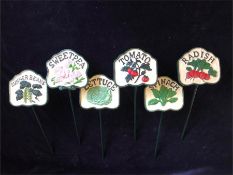 A set of six cast iron vegetable signs for the garden