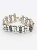 A silver filigree bracelet set with three rows of pearls and marcasites