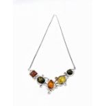 A silver necklace with Amber