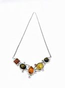 A silver necklace with Amber