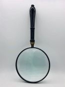 A 6" silver plate magnifying glass
