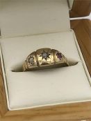 A 15ct gold ring with diamond and rubies (1.8g)