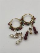 Three pairs of earrings on Asian gold settings (Total weight 12.8g)