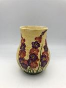 A Moorcroft vase 13cm tall yellow grounds