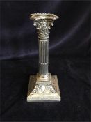 A silver candlestick, hallmarked base.