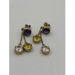 A pair of 9ct yellow gold earrings with three stone drop.