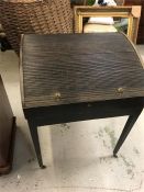 An 18th Century roll top writing desk with an ebonised finish.
