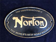 Black and gold Norton sign in cast iron