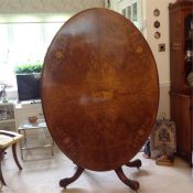 An oval dining table with fruit wood inlay